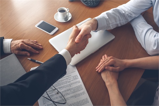 people-shaking-hands-at-desk